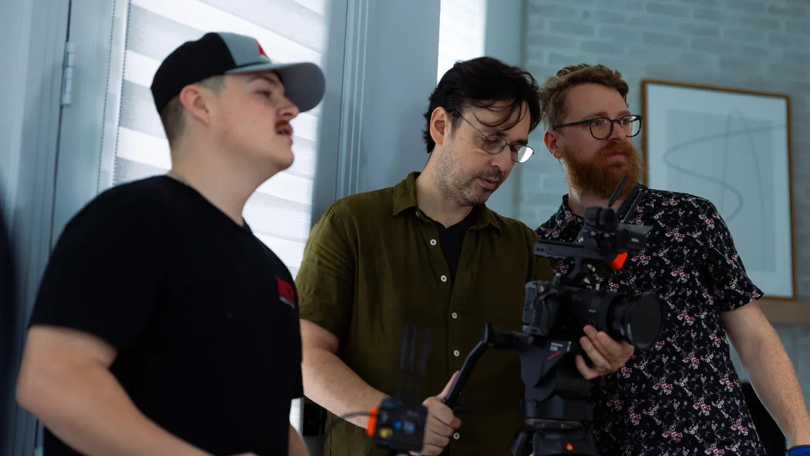The crew and a client reviewing a take on set