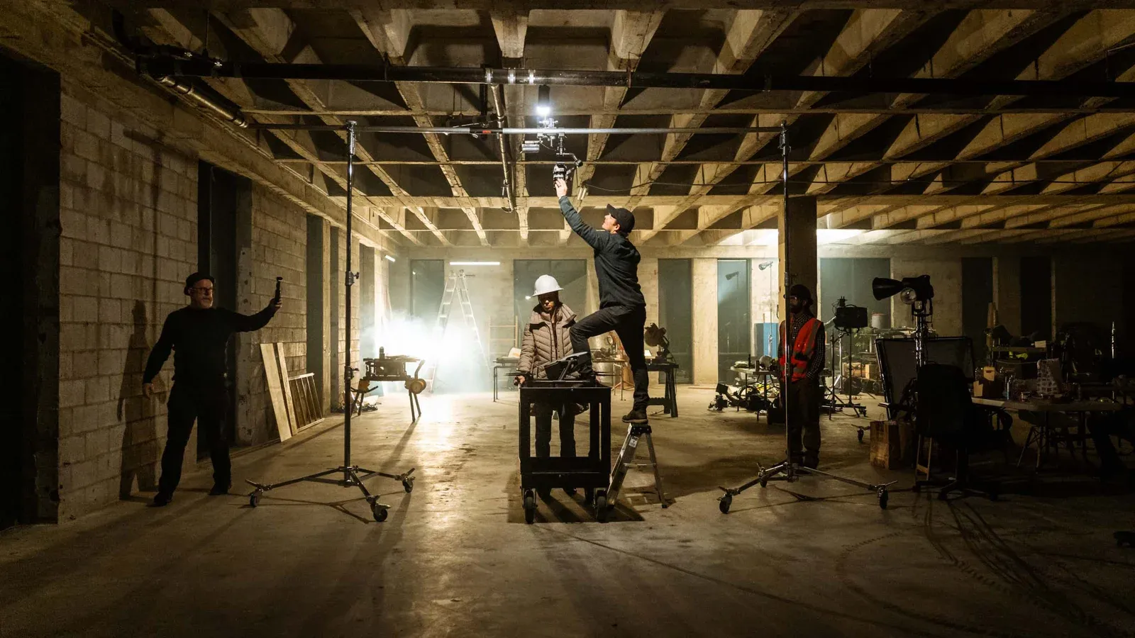 Setting lights in an empty warehouse before a shoot
