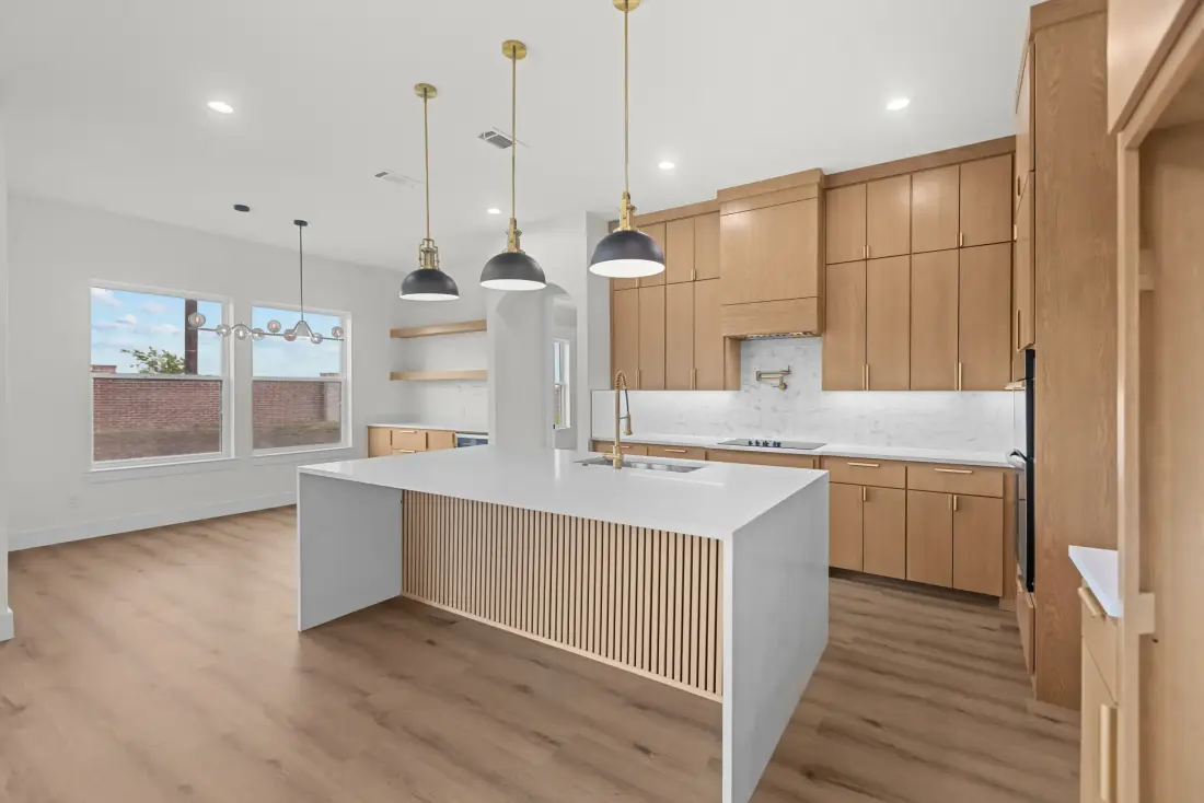 Open-plan kitchen photographed with hand-blended HDR, island and pendant lights even throughout